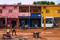Vibrant city street in Africa with colorful buildings and local activity.