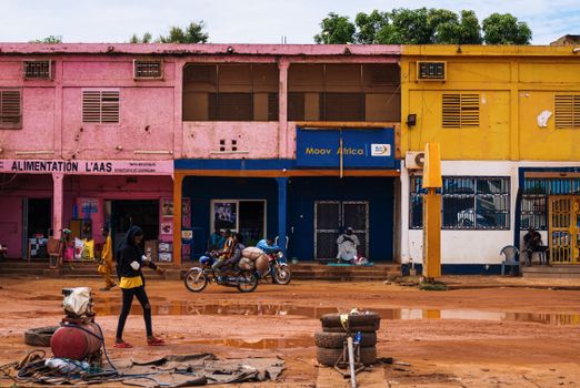 Vibrant city street in Africa with colorful buildings and local activity.