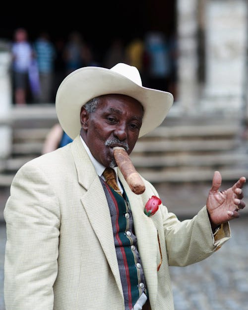 Man in Hat and Suit Posing with Huge Cigar