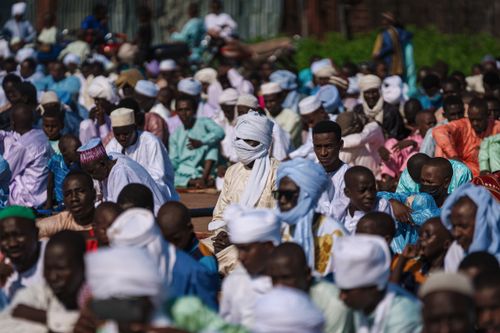 Free A large outdoor group gathering in colorful traditional clothing and turbans under the sun. Stock Photo