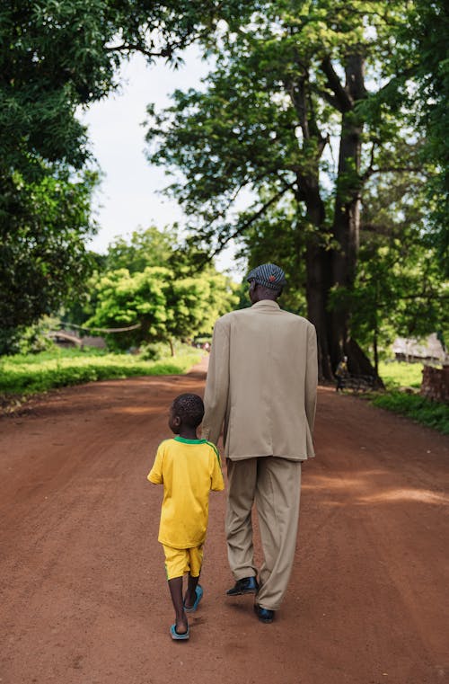 Father Walking with Son on Dirt Road