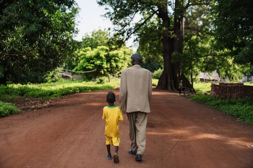 Father and Son Walking on Dirt Road