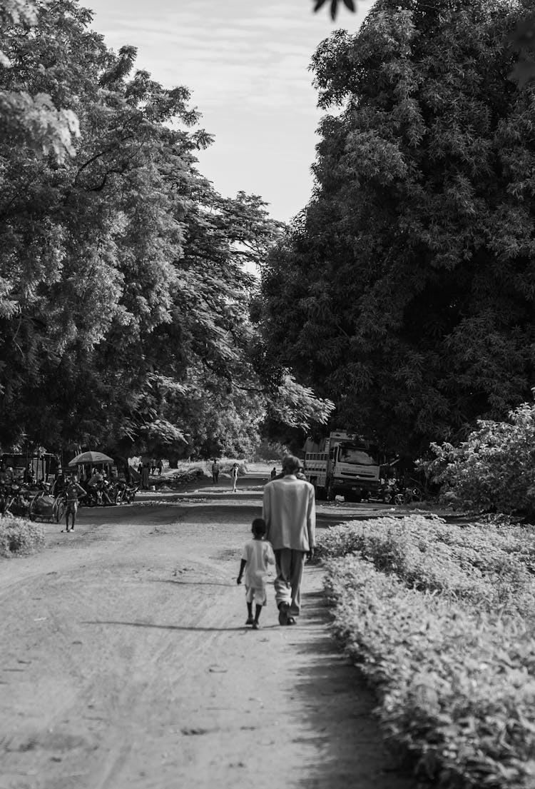 Father Walking With Son In Black And White