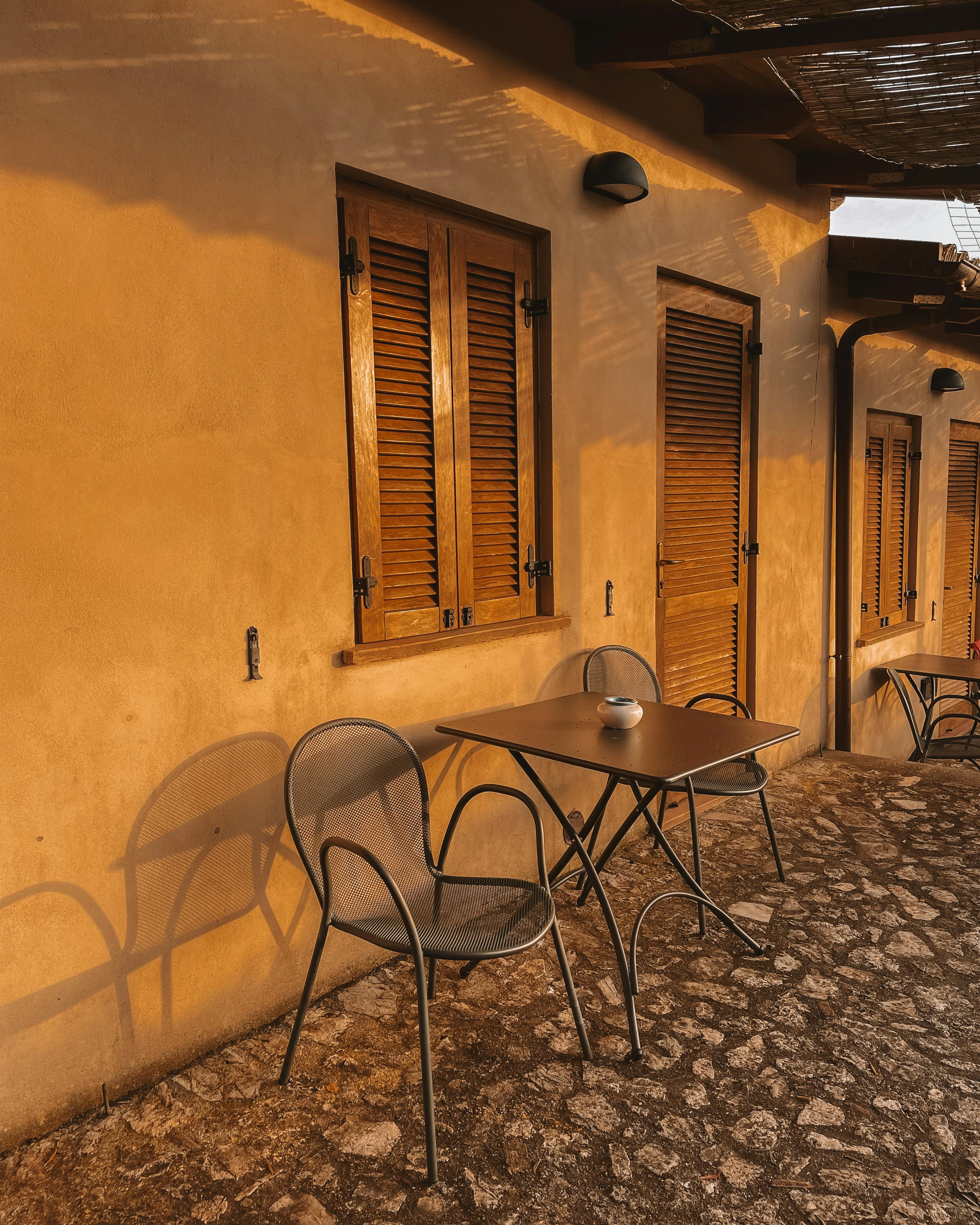Cozy outdoor seating at a Mediterranean-style patio bathed in warm evening light.