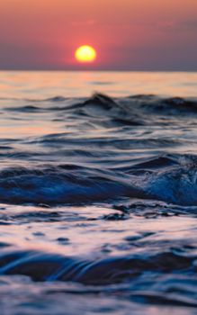 Capture the tranquility of a sunset over the gentle waves in Novigrad, Croatia. Perfect for backgrounds.