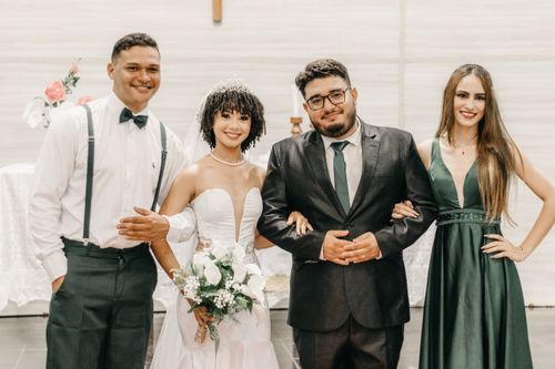 Free Smiling newlyweds and guests posing together at a wedding ceremony indoors. Stock Photo