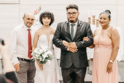 Free Beautiful family portrait at an indoor wedding ceremony highlighting elegance and love. Stock Photo