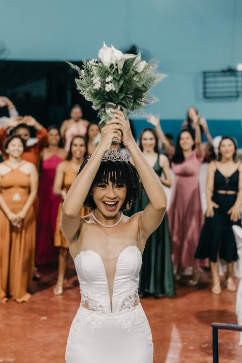 Happy Bride Holding Bouquet of Flowers in Hands