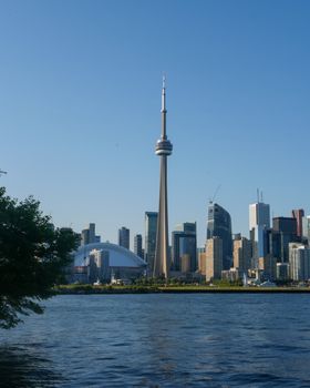 Iconic view of Toronto skyline featuring the CN Tower, captured on a clear day from across the water.