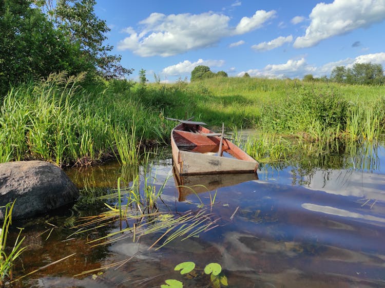 Sunken Wooden Boat On Lakeshore