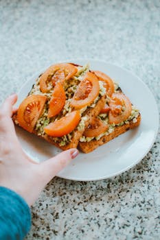 Close-up of delicious homemade avocado tomato toast on a plate.