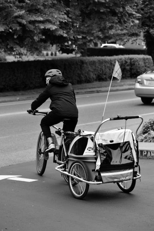Man Riding a Bike with Cart in Black and White