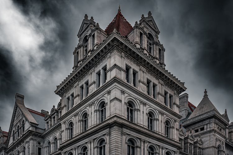 Low Angle Shot Of The New York State Capitol Building Under Dark Clouds, Albany, New York, USA 