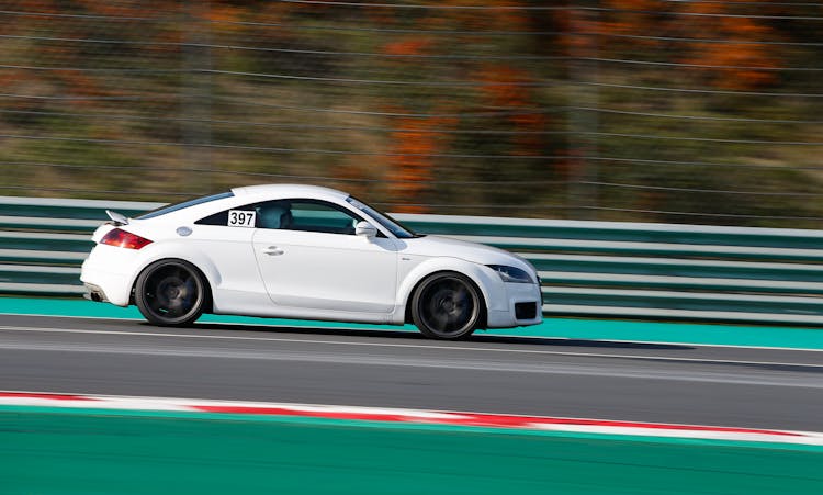 White Car Driving In Race