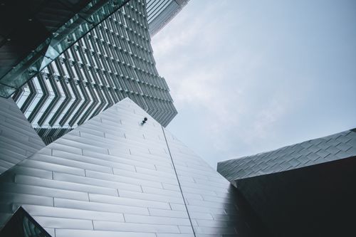 Free Low-angle view of a modern building facade highlighting geometric design and metal texture. Stock Photo
