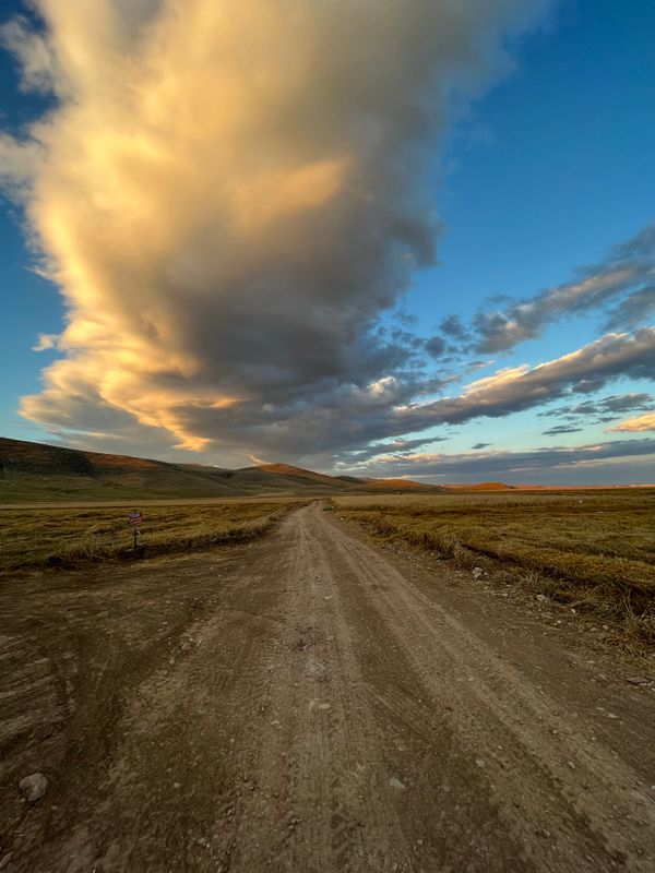 Dirt road across flat plains under a big sky