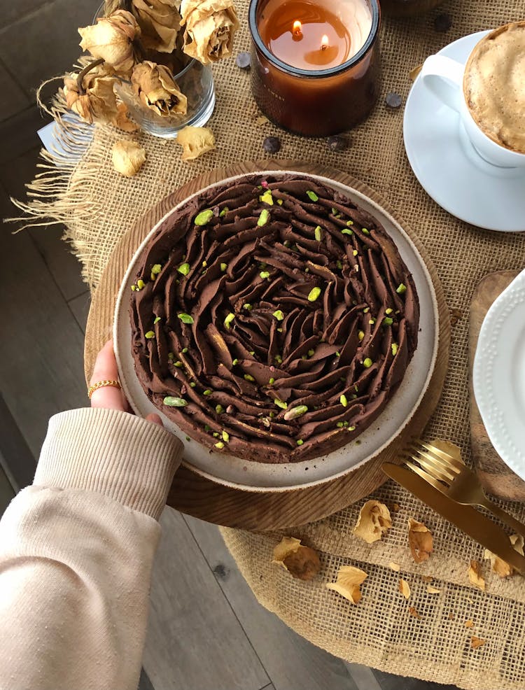 Woman Hand Holding Plate With Chocolate Cake