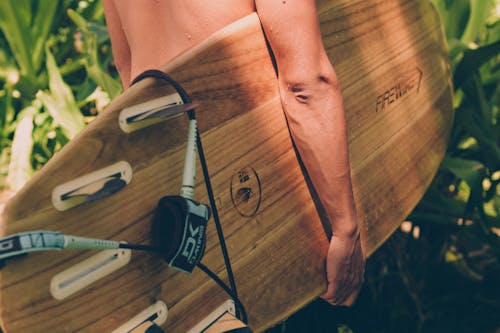 Free Close-Up Photo of Person Carrying Surfboard Stock Photo