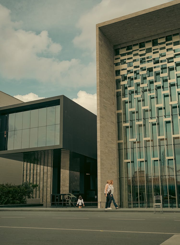 People Walking Near Modern Buildings In City