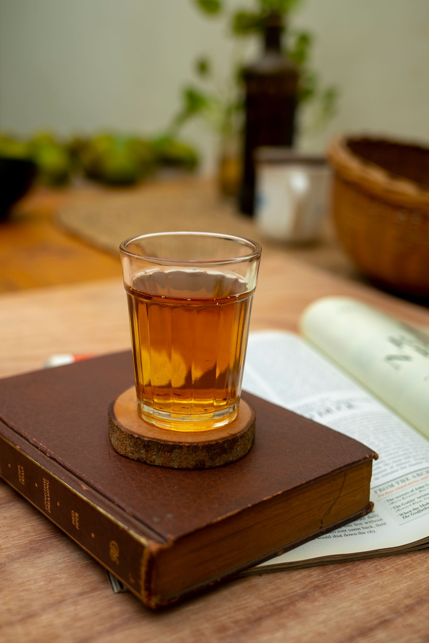 A warm glass of tea placed on an old book.