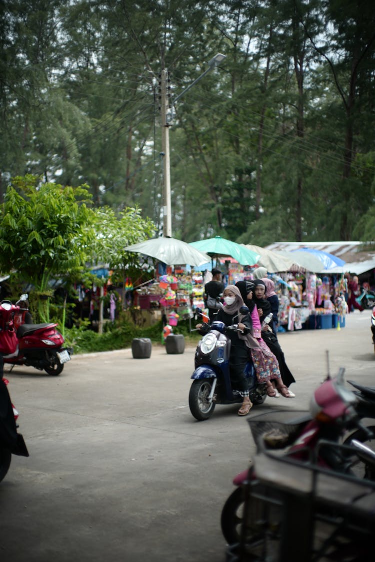 Women Riding Motor Scooter In Park