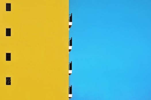 Bright yellow building facade contrasts with clear blue sky in Hội An, Vietnam.