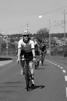 Black and white image of cyclists racing through the streets of Jönköping, Sweden.