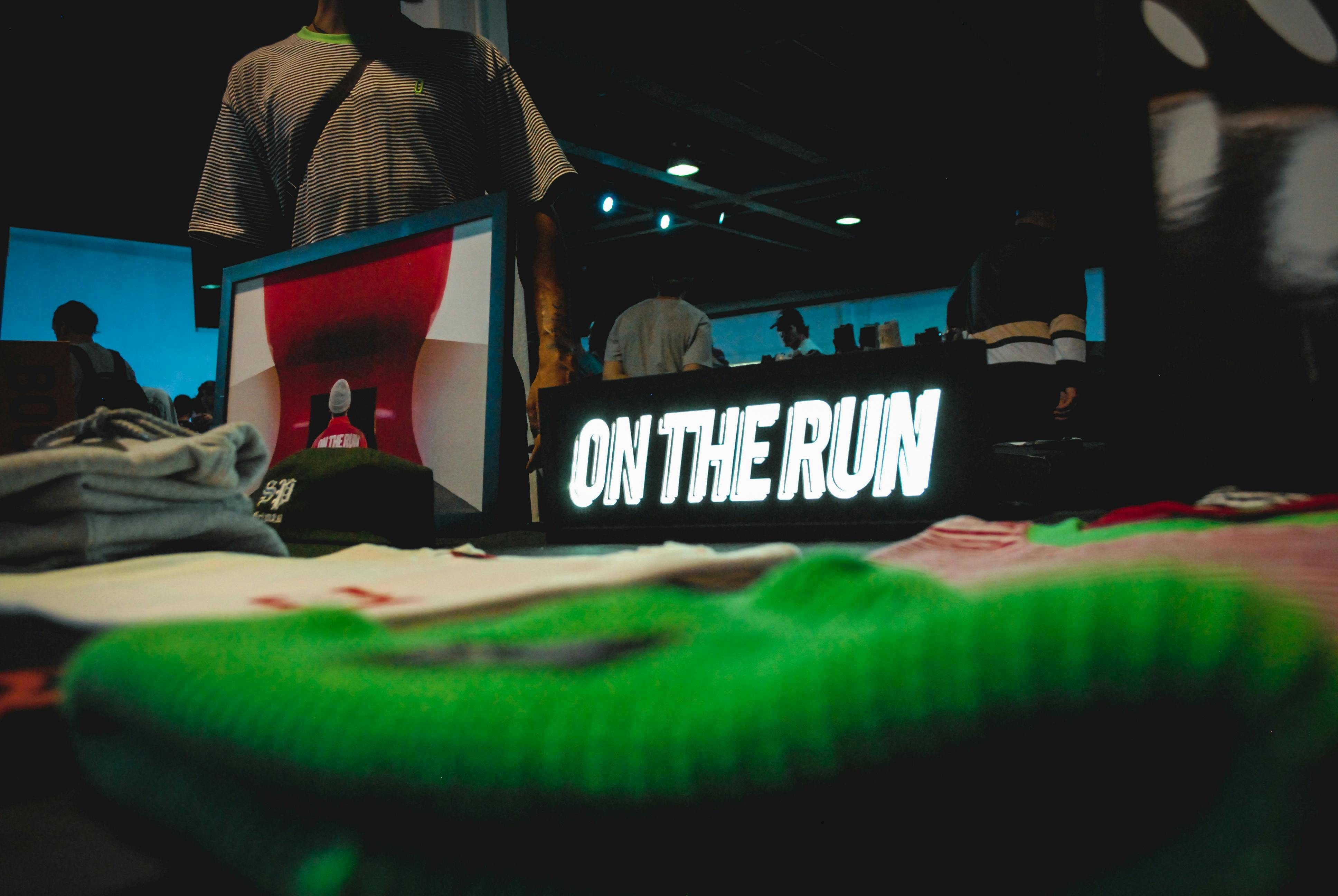 Fashion model poses near high-end clothing on a modern modular display system