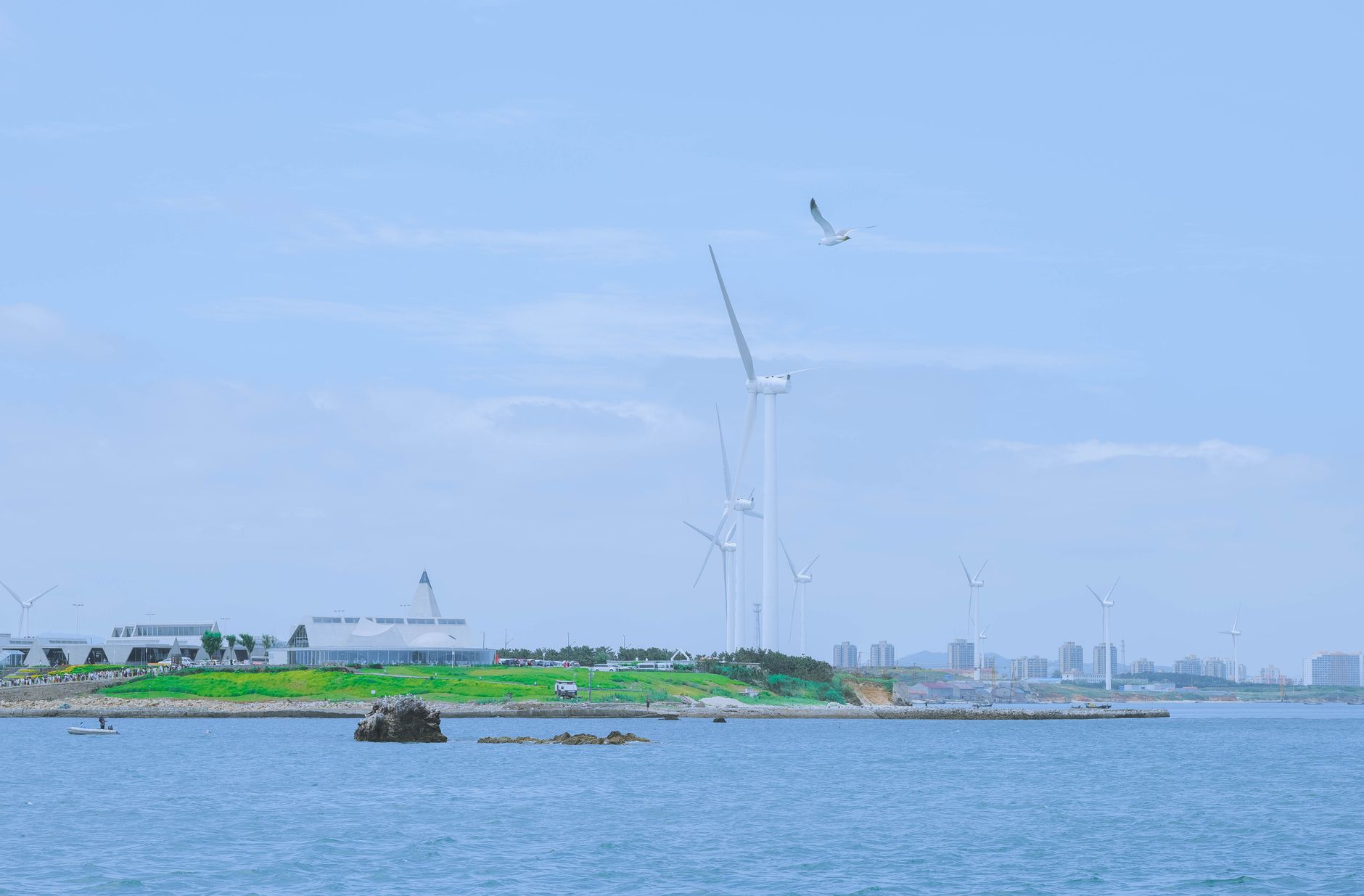 Scenic view of wind turbines on the seashore in Weihai, Shandong, China, highlighting renewable energy.
