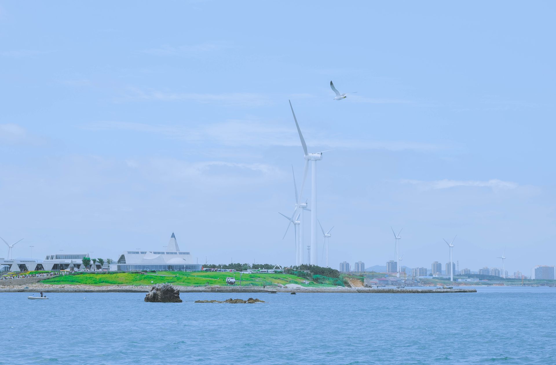 Scenic view of wind turbines on the seashore in Weihai, Shandong, China, highlighting renewable energy.