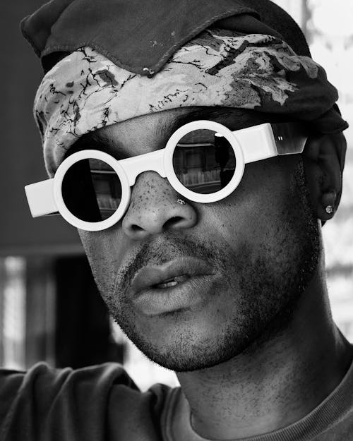 Black and White Photo of a Young Man Wearing a Bandana and Retro Sunglasses