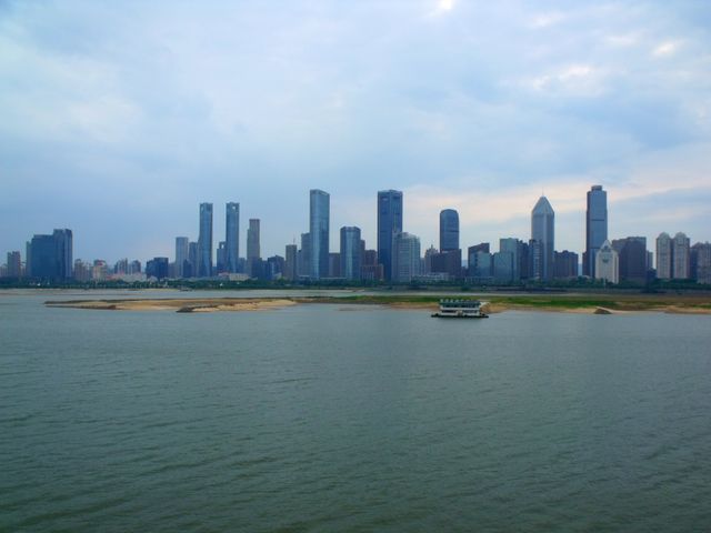 Panoramic view of Nanchang's skyline across the harbor with modern skyscrapers and river.