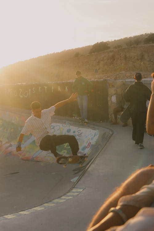 Young People Skateboarding on a Concrete Ramp