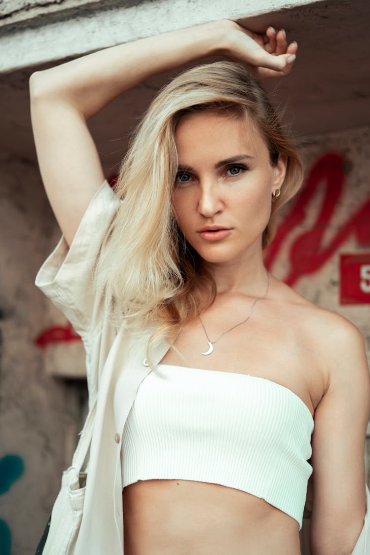 Young Blonde Woman Posing In White Bandeau And Blouse