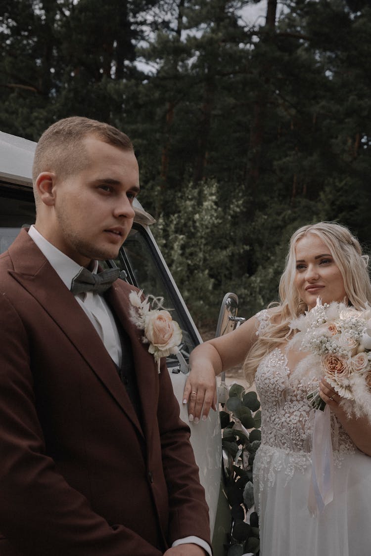 Newlyweds Standing In Front Of A Van