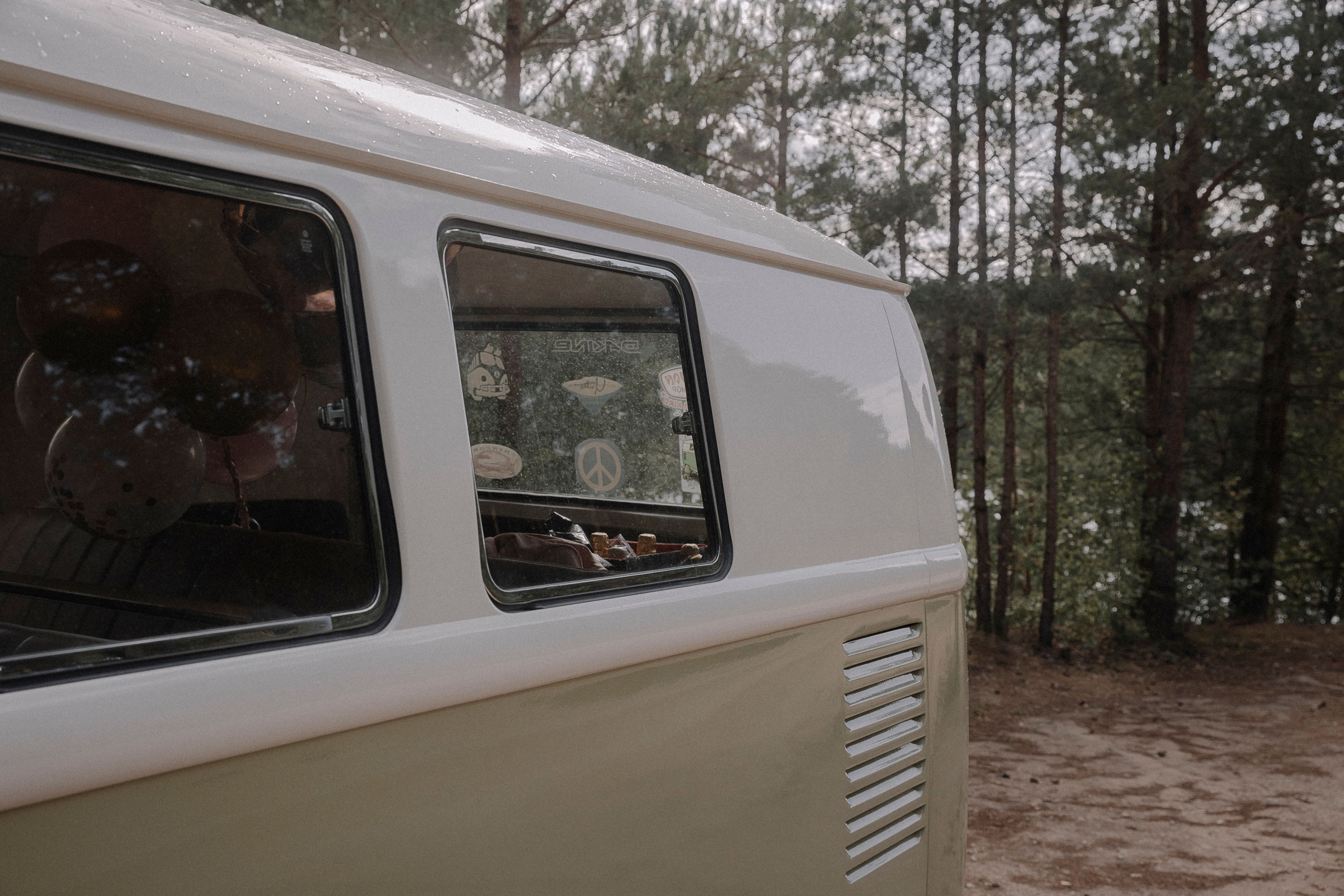 Retro Volkswagen van parked in a serene forest setting
