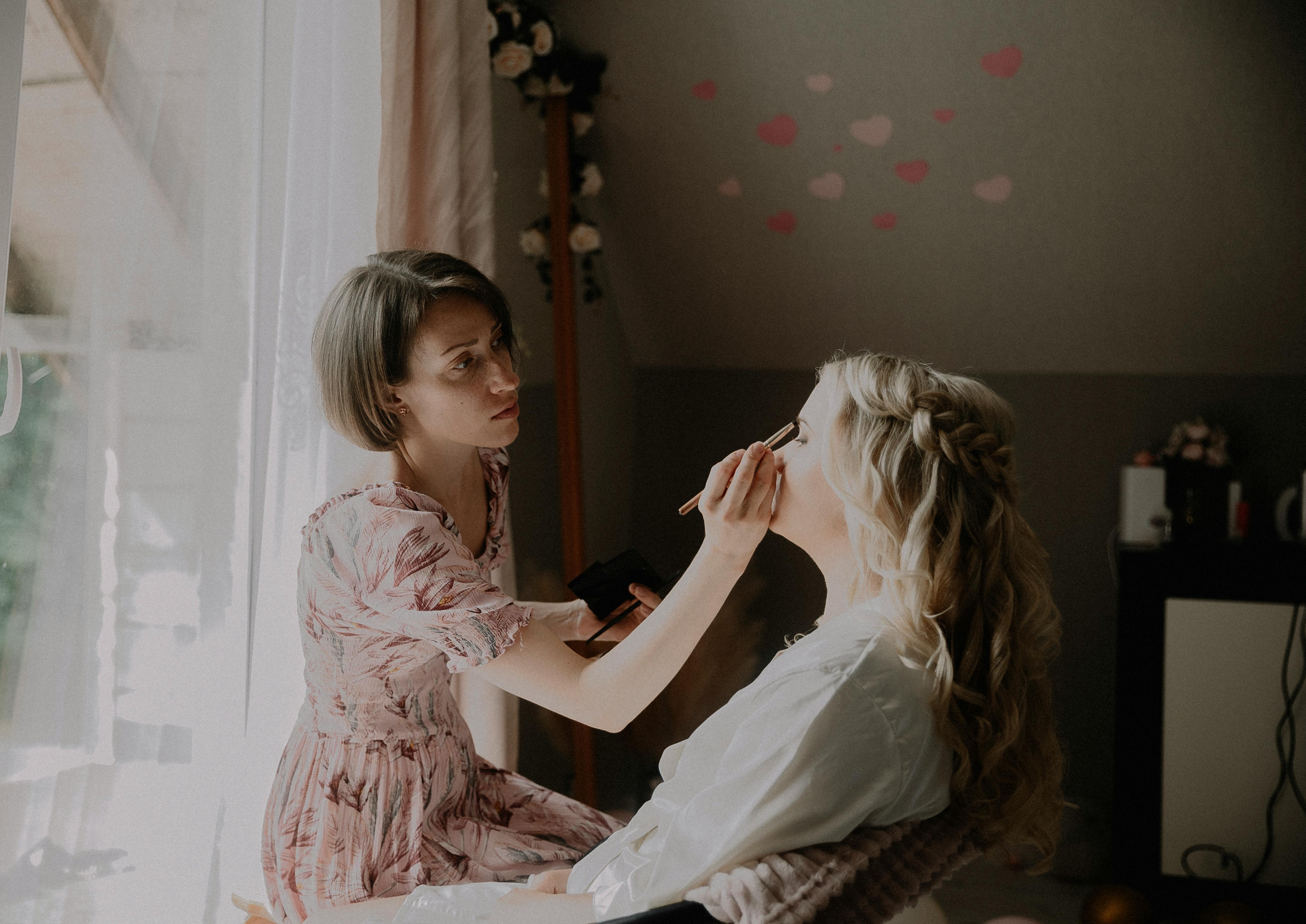 Makeup artist applying bridal eye makeup close up