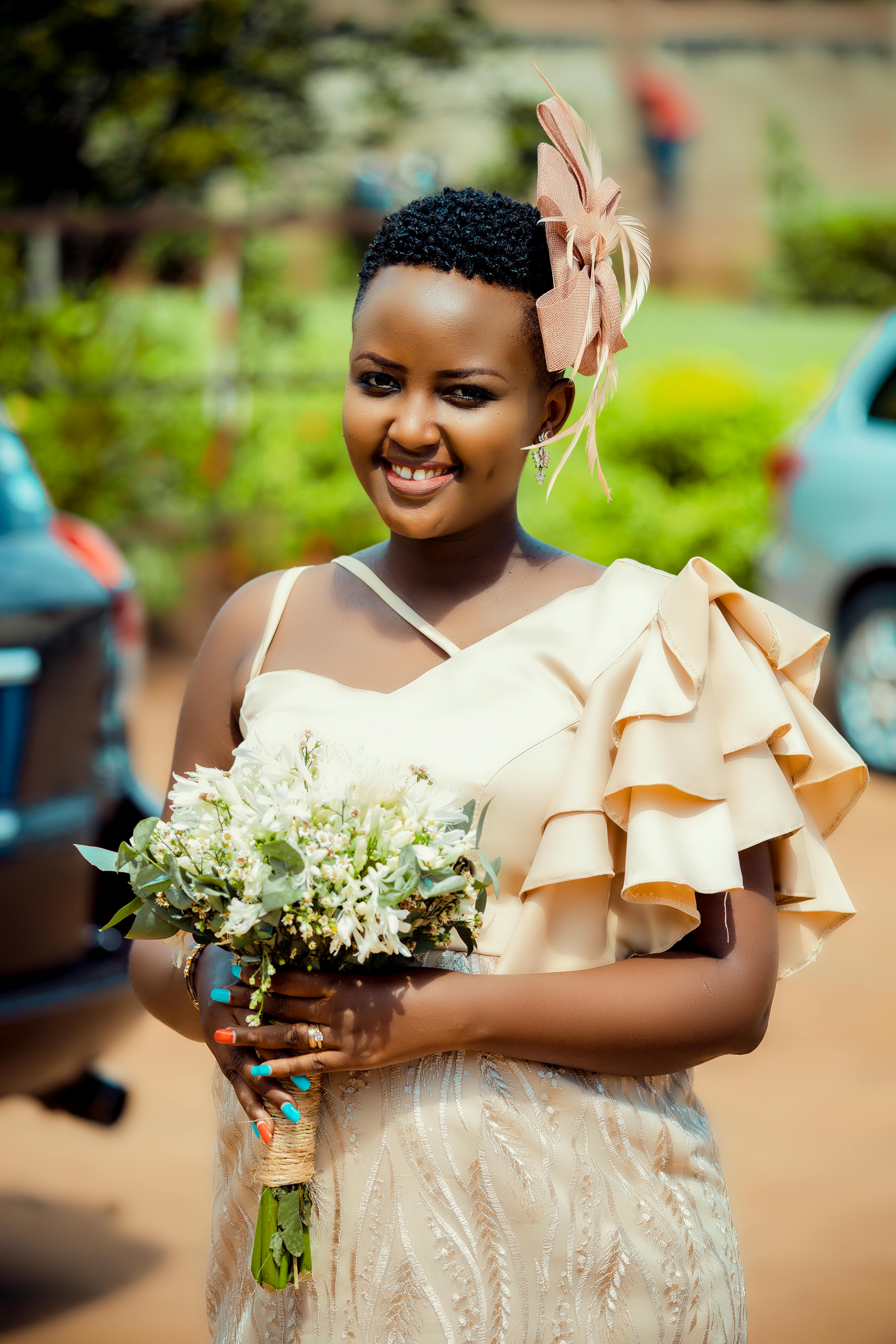 Pretty Woman in Dress with Flowers in Hands Free Stock Photo