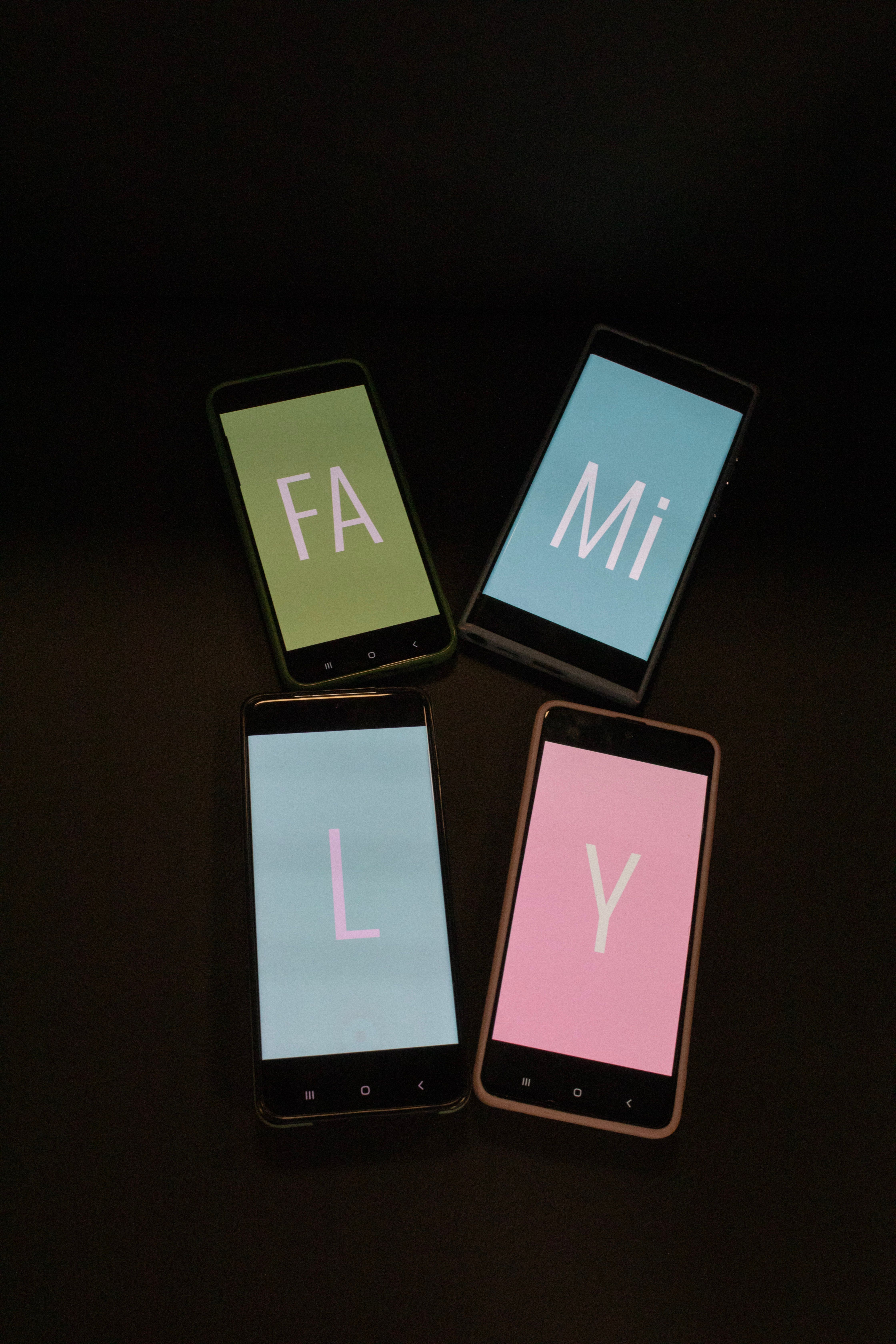 Smartphones with Wallpapers Saying Family · Free Stock Photo
