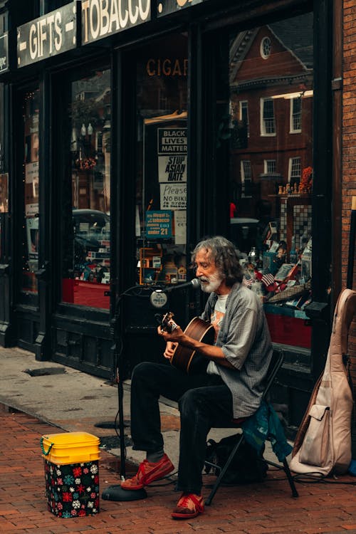 Elderly Street Musician on Sidewalk