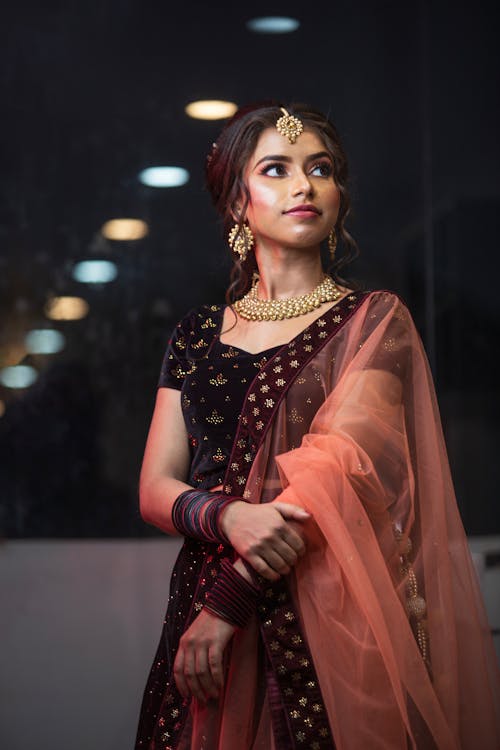 Pretty Young Woman in Dress with Golden Necklace