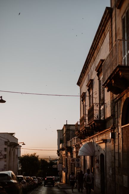 Charming street scene in Ostuni, Italy, highlighting local architecture during twilight.
