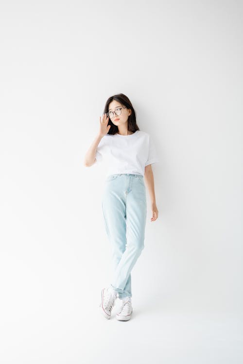 Brunette Woman Wearing Jeans Posing in Studio 