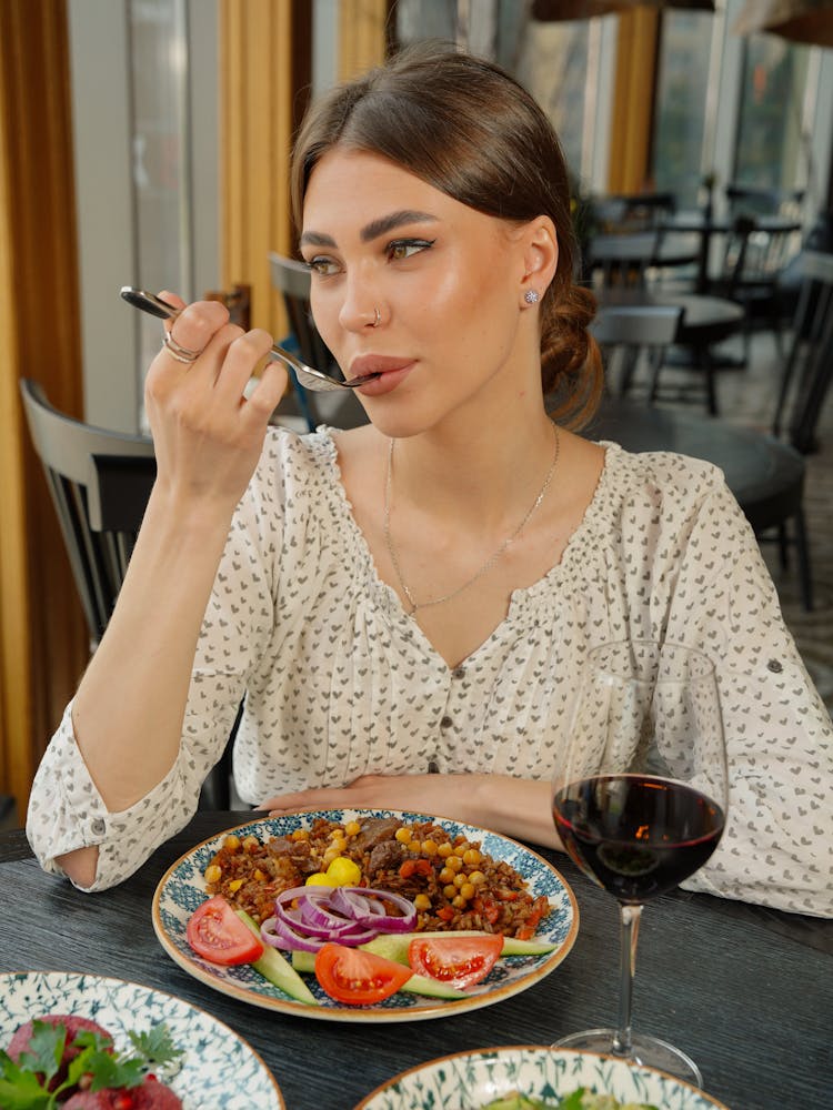 Photo Of A Woman Eating A Dinner