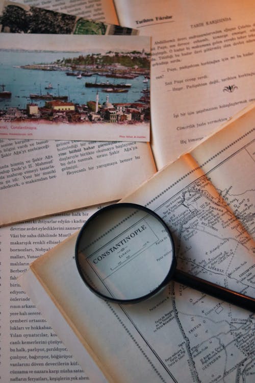 A Magnifying Glass Lying on a Vintage Book with a Map 