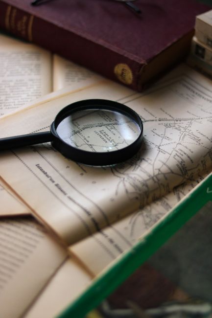 A vintage exploration scene with a map and magnifying glass, hinting at discovery and adventure.