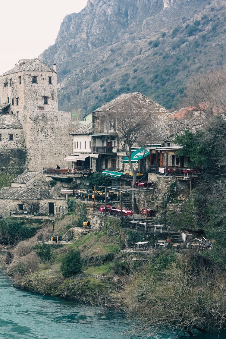 Vintage Buildings In Village Near River