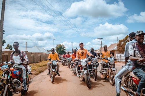 People on Motorcyles in Village