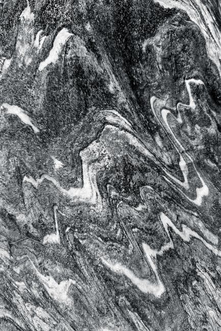 Close-up of a black and white stone texture with abstract patterns.