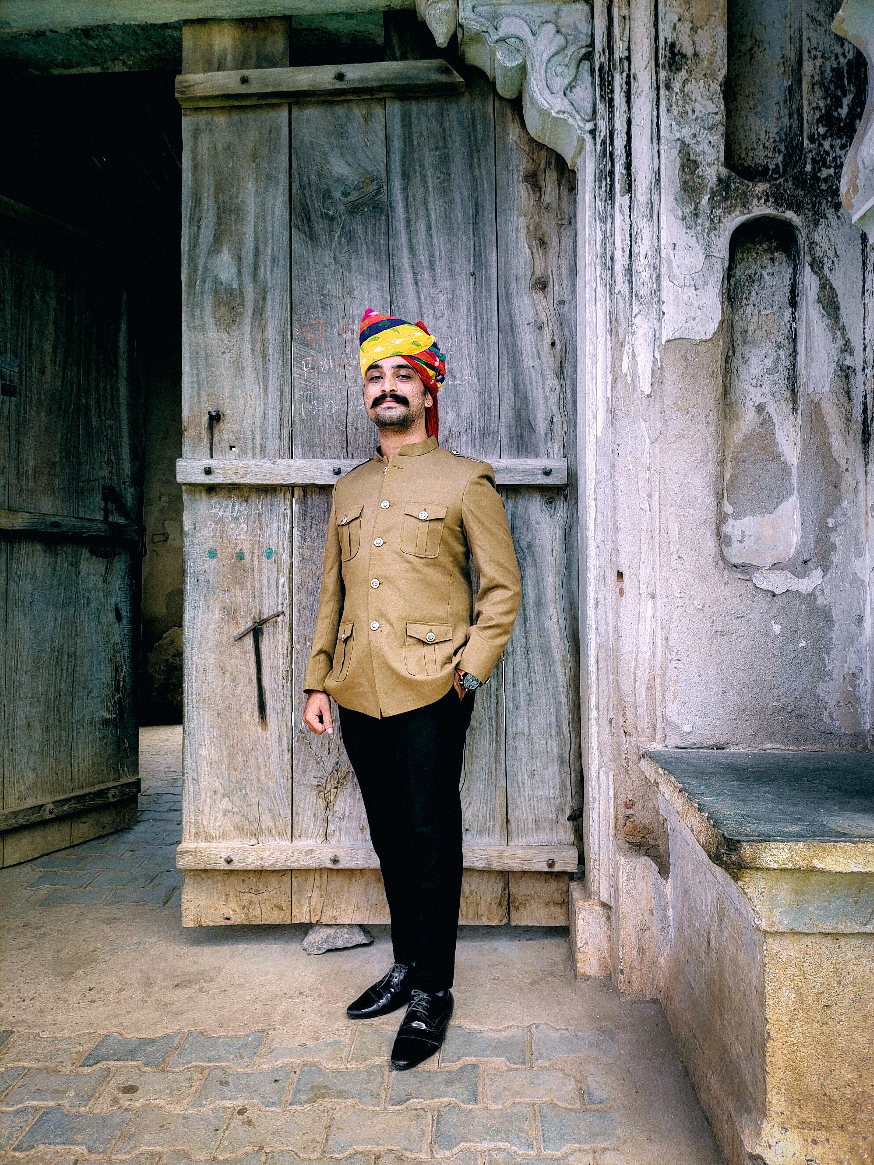 A Man with Mustache Wearing a Turban and Standing in front of Old ...